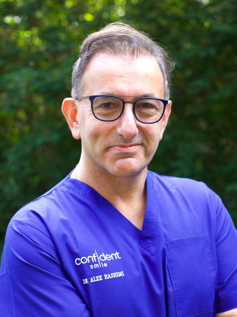 Dr Alex Hashemi, founder of Confident Smile in Shepperton, in scrubs and glasses